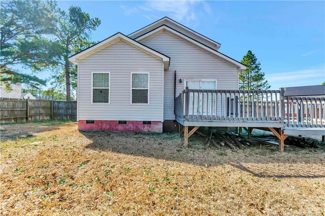 back of house featuring a deck, crawl space, and fence