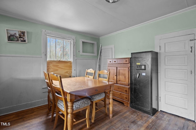 dining room featuring a wainscoted wall, dark wood finished floors, and ornamental molding