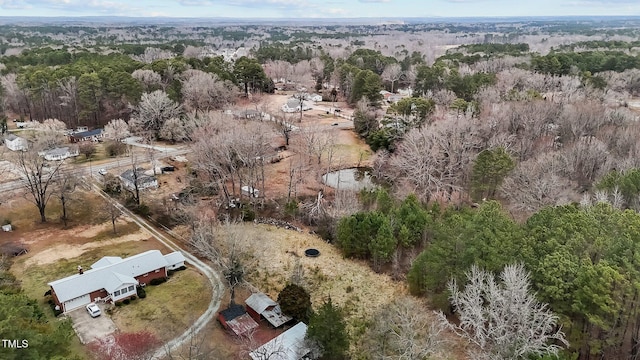 drone / aerial view featuring a forest view