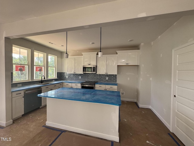 247 Meadowbark Bnd Unit 29, Garner, NC 27529 - kitchen featuring appliances with stainless steel finishes, white cabinetry, tasteful backsplash, a kitchen island, and pendant lighting