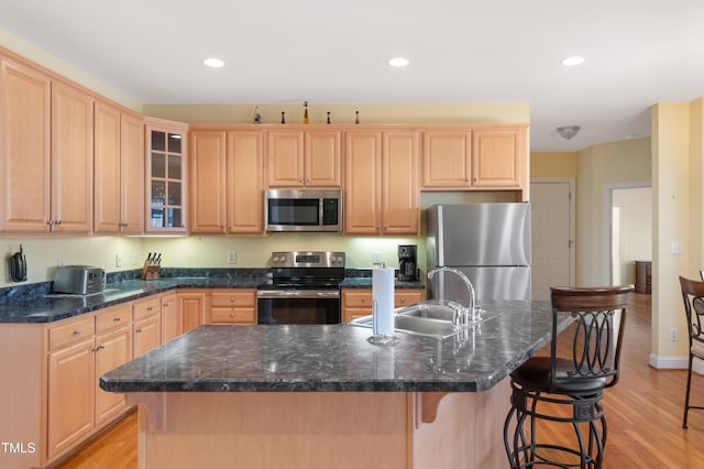 kitchen featuring light brown cabinets, stainless steel appliances, a sink, and recessed lighting