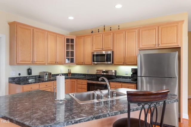 kitchen with stainless steel appliances, recessed lighting, glass insert cabinets, and a breakfast bar