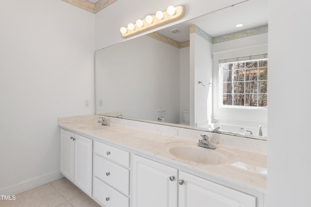 bathroom featuring toilet, tile patterned flooring, double vanity, and a sink