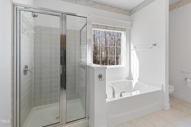 full bathroom featuring toilet, tile patterned flooring, a shower stall, and a bath