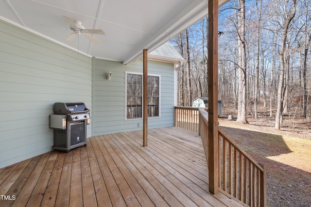 wooden deck featuring a ceiling fan and grilling area