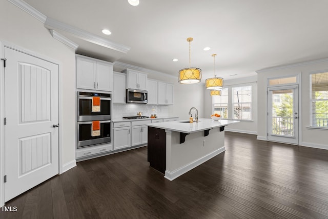 kitchen featuring decorative backsplash, crown molding, light countertops, and stainless steel appliances