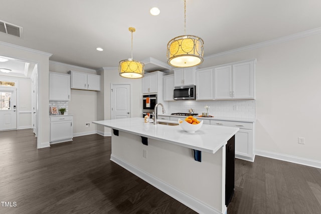 kitchen with a sink, visible vents, appliances with stainless steel finishes, and white cabinets