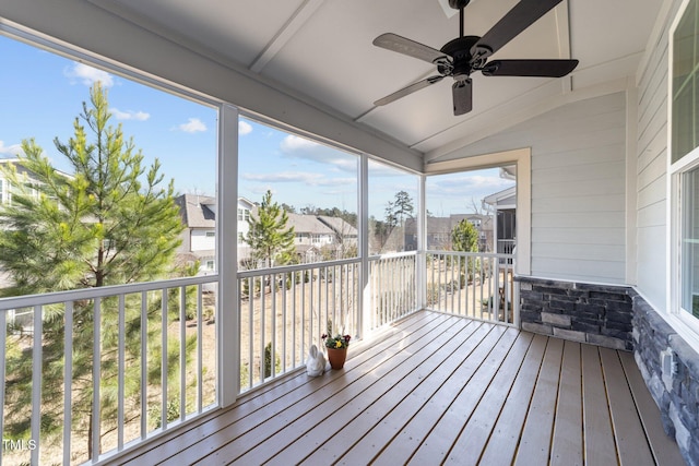 wooden terrace with a ceiling fan and a residential view