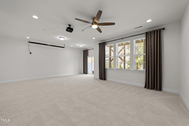 spare room featuring recessed lighting, visible vents, light carpet, and baseboards