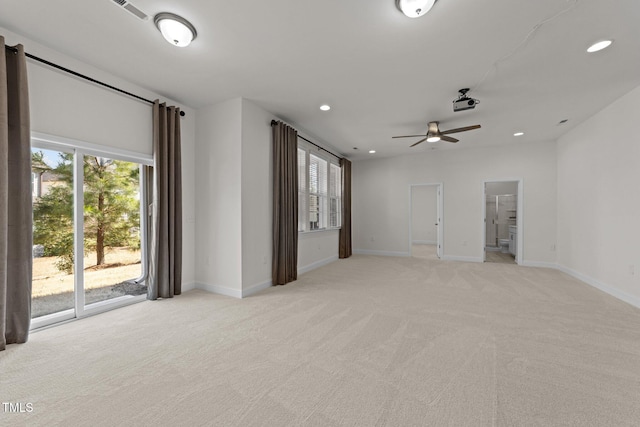 spare room featuring recessed lighting, baseboards, plenty of natural light, and light colored carpet