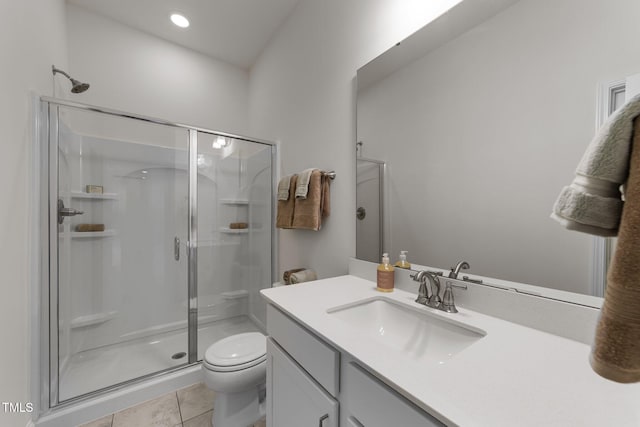 bathroom featuring vanity, a shower stall, toilet, and tile patterned flooring