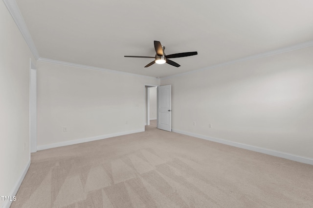 spare room featuring baseboards, light carpet, ornamental molding, and a ceiling fan