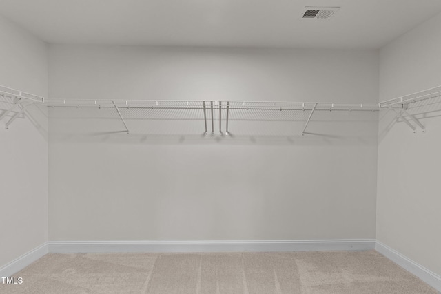 walk in closet with visible vents and carpet flooring