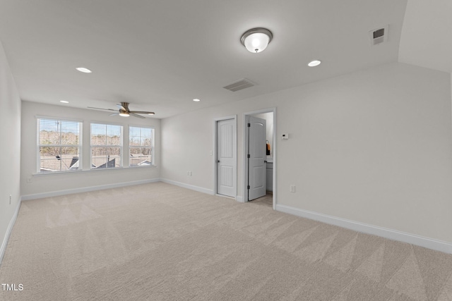 spare room featuring recessed lighting, visible vents, light colored carpet, and baseboards