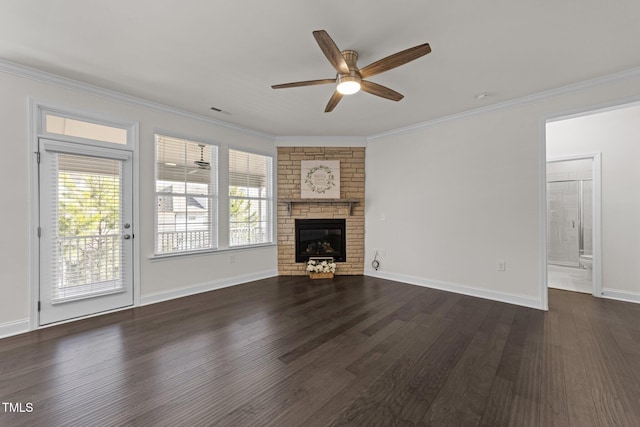 unfurnished living room featuring crown molding, a fireplace, dark wood-type flooring, and a healthy amount of sunlight