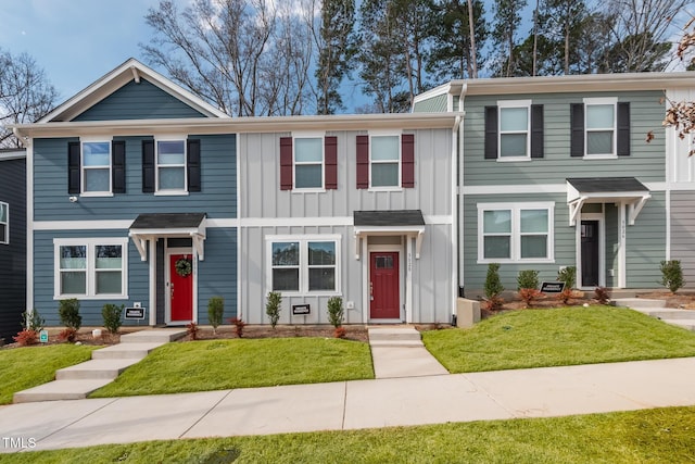 view of front of property featuring a front lawn and board and batten siding