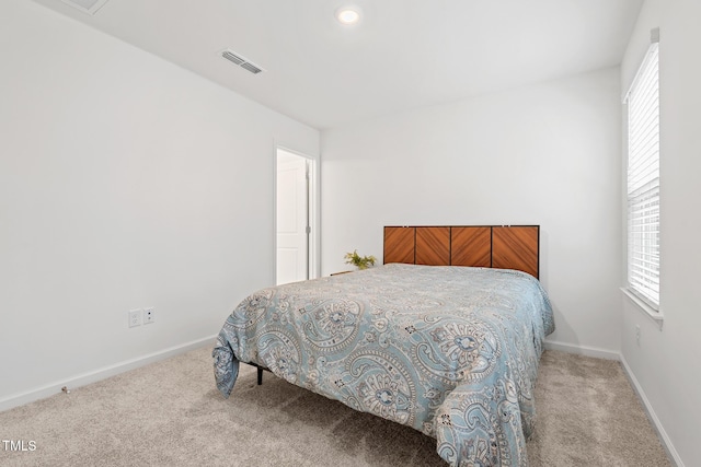 carpeted bedroom with visible vents and baseboards