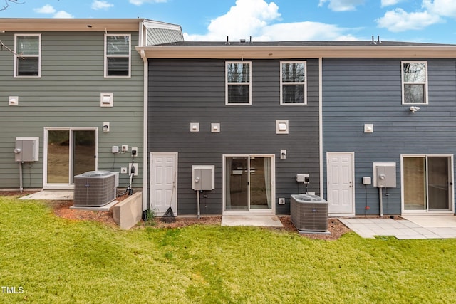 rear view of property with a patio area, a lawn, and central AC unit