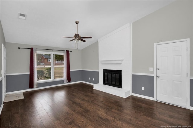 unfurnished living room featuring a fireplace, lofted ceiling, visible vents, ceiling fan, and wood finished floors