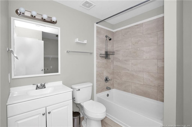 bathroom with shower / washtub combination, visible vents, vanity, and toilet