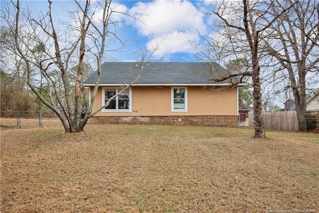 view of property exterior with fence private yard and a lawn