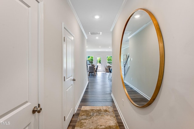 hall with crown molding, dark wood finished floors, recessed lighting, visible vents, and baseboards