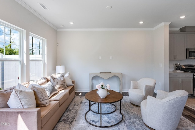 living room featuring ornamental molding, recessed lighting, visible vents, and wood finished floors