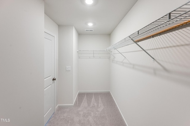 spacious closet with visible vents and carpet flooring