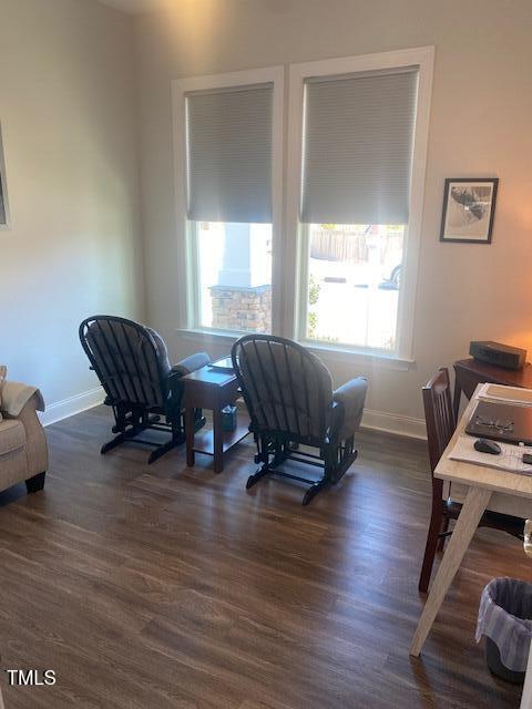 office space featuring dark wood-style flooring, plenty of natural light, and baseboards