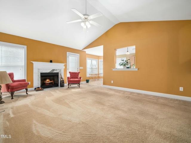 living area featuring carpet floors, a fireplace, baseboards, and ceiling fan