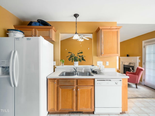 kitchen featuring white appliances, visible vents, light countertops, a fireplace, and a sink