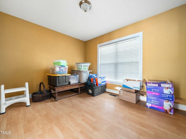 interior space featuring baseboards and wood finished floors