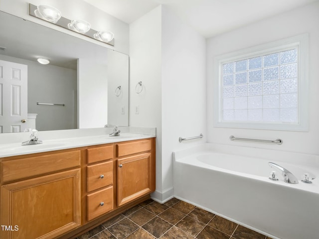 full bathroom featuring a garden tub, double vanity, a sink, and visible vents