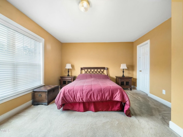 carpeted bedroom featuring baseboards