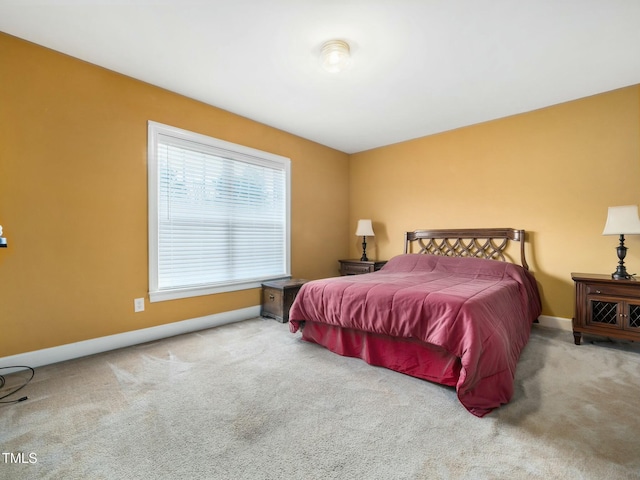 bedroom with carpet flooring and baseboards