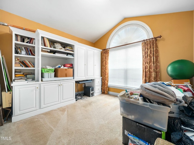 interior space featuring lofted ceiling, carpet, and plenty of natural light