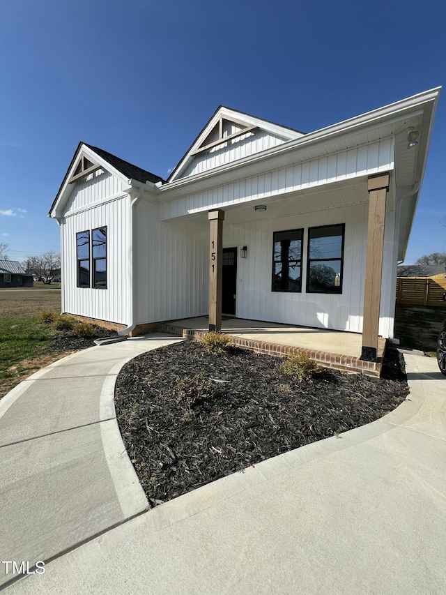 modern farmhouse featuring board and batten siding and a porch