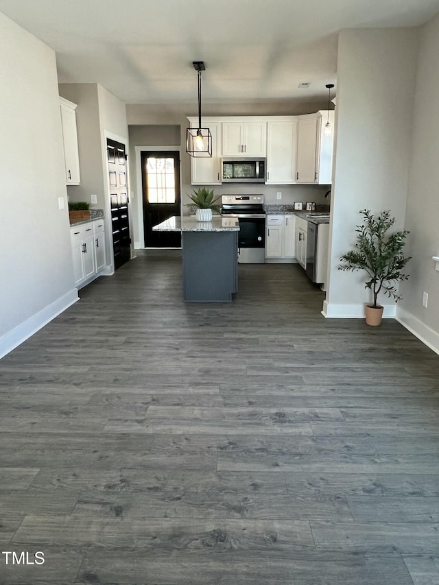 kitchen with stainless steel appliances, dark wood-type flooring, and white cabinetry