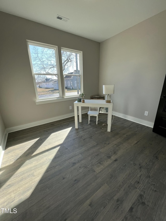 home office featuring baseboards, visible vents, and dark wood finished floors