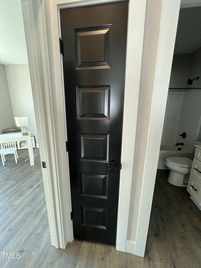 full bathroom featuring toilet, shower / bath combination, wood finished floors, and vanity