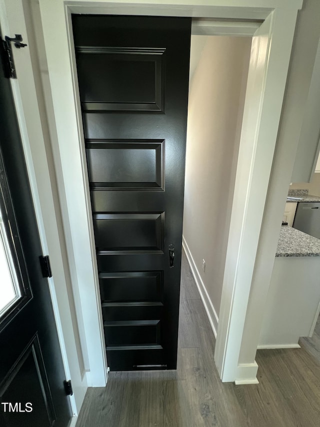 interior space with wood finished floors and baseboards