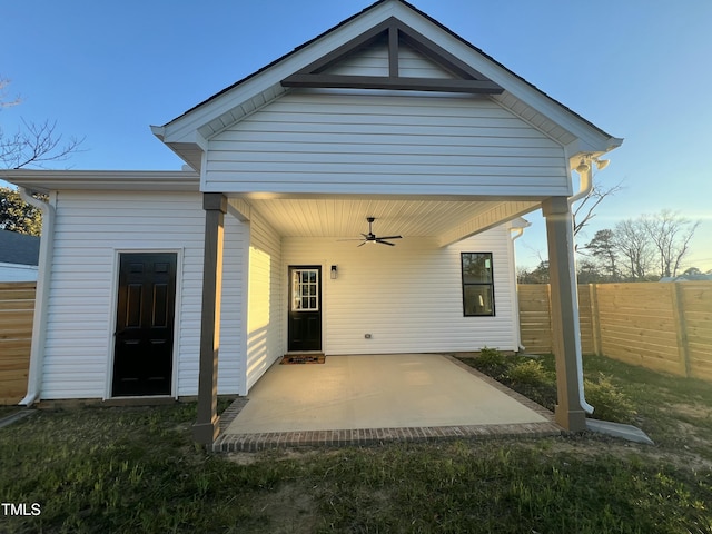 rear view of house featuring ceiling fan, fence, and a patio