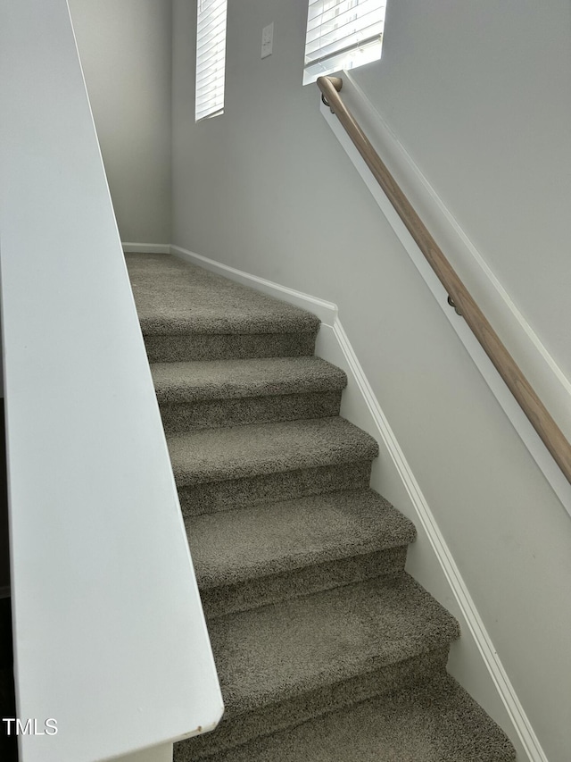 stairway featuring baseboards