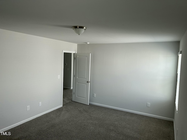 unfurnished room featuring baseboards and carpet floors