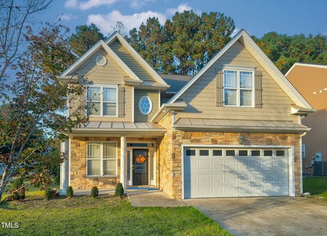 view of front of house with a garage, stone siding, concrete driveway, and a standing seam roof