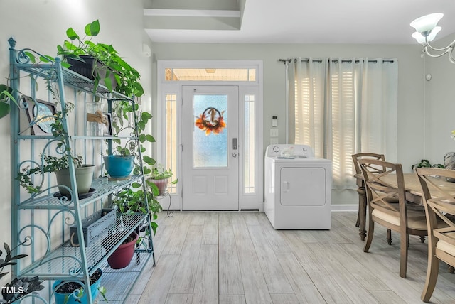 foyer entrance featuring washer / dryer and wood finished floors