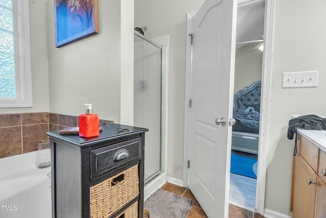 full bath featuring a shower stall, tile patterned flooring, and vanity