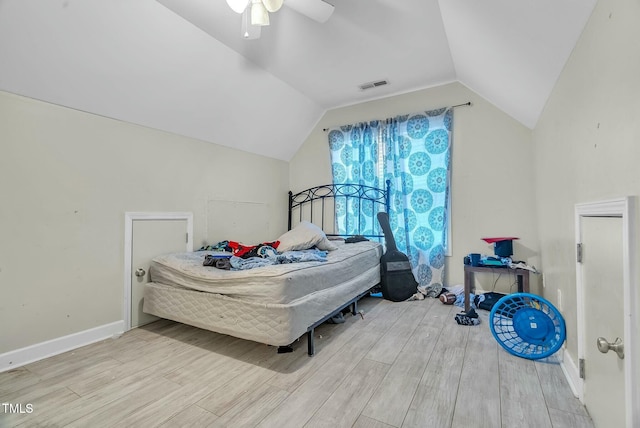 bedroom with lofted ceiling, ceiling fan, visible vents, baseboards, and light wood finished floors