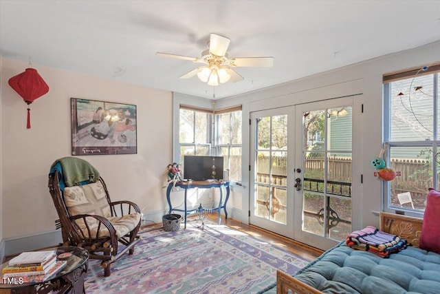 office with baseboards, a ceiling fan, wood finished floors, and french doors