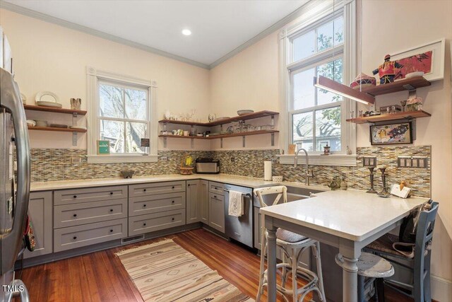 kitchen with stainless steel appliances, gray cabinets, decorative backsplash, and open shelves